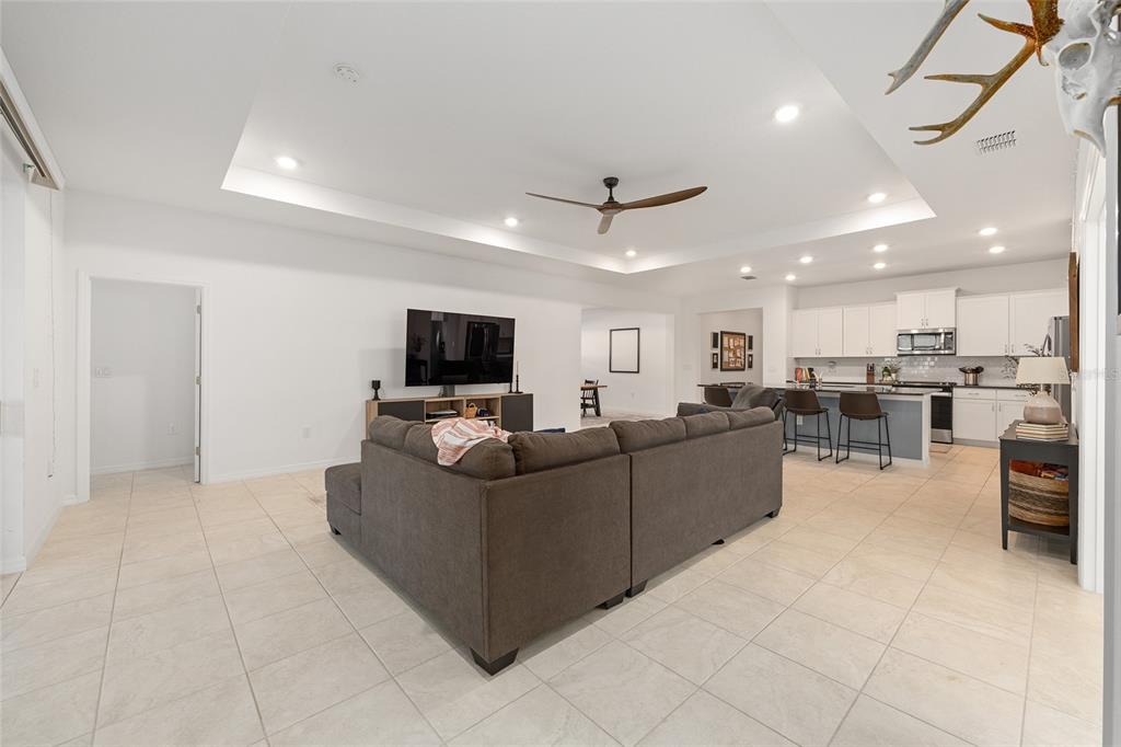 7431 Southwest 65th Place Road Ocala, FL 34474 - Photo 14 of 49 a living room with furniture and a flat screen tv