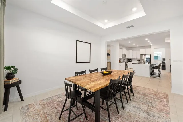 a view of a dining room and livingroom with furniture wooden floor and a rug