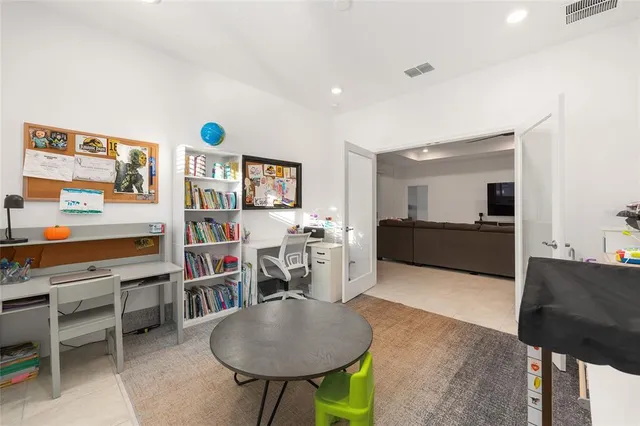 a living room with furniture and a kitchen