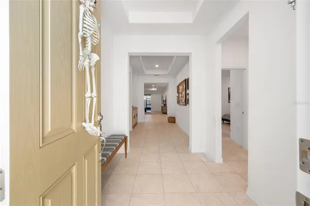a view of a hallway with wooden floor and furniture