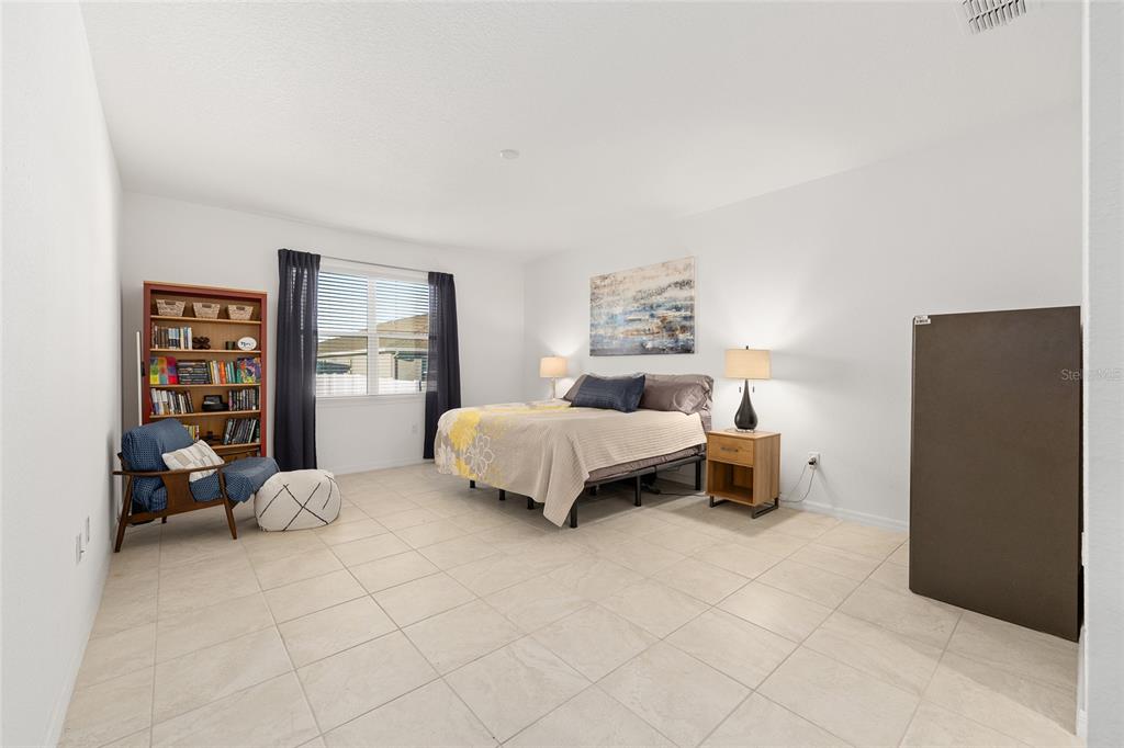 7431 Southwest 65th Place Road Ocala, FL 34474 - Photo 21 of 49 a bedroom with a bed and a cabinets