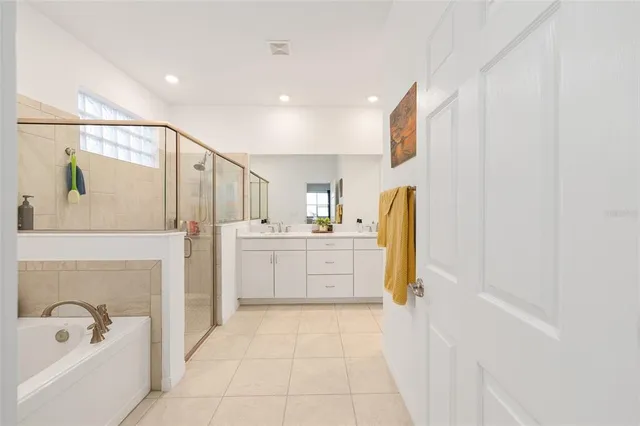 a bathroom with a tub sink and mirror