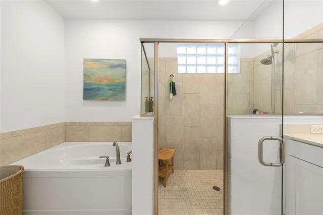 a bathroom with a bathtub and a shower