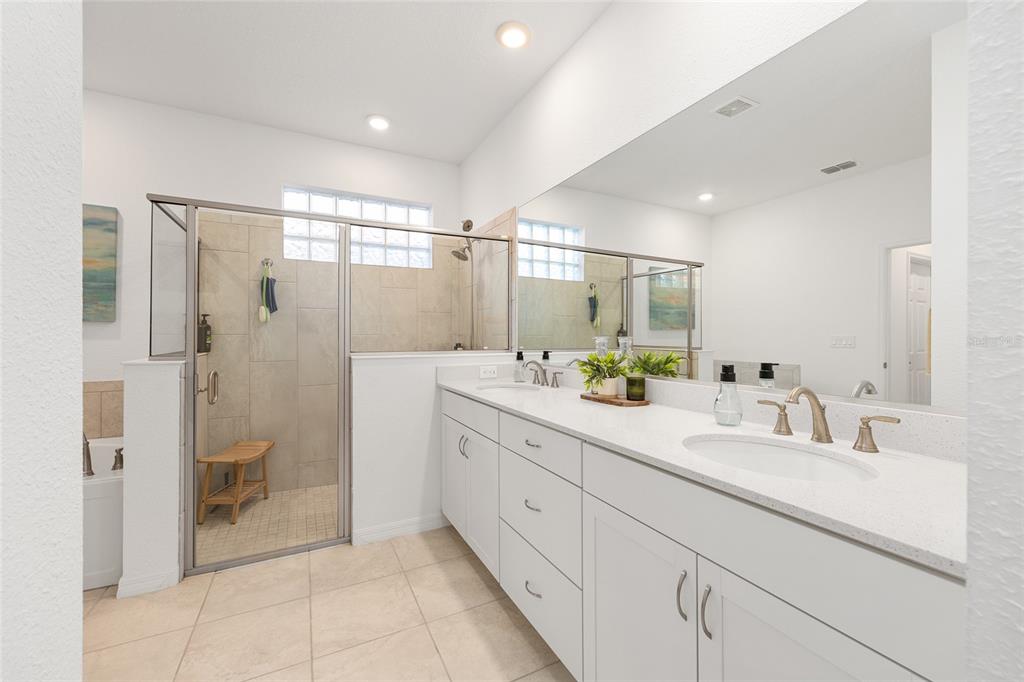 7431 Southwest 65th Place Road Ocala, FL 34474 - Photo 25 of 49 a bathroom with a double vanity sink toilet and shower