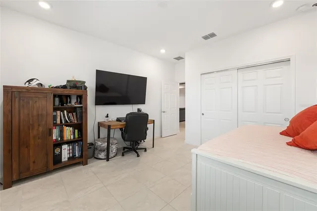 a view of a workspace with furniture and a book shelf