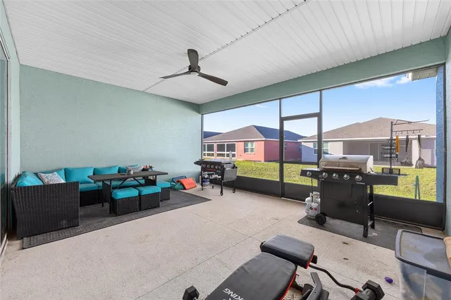 a living room with furniture and a floor to ceiling window