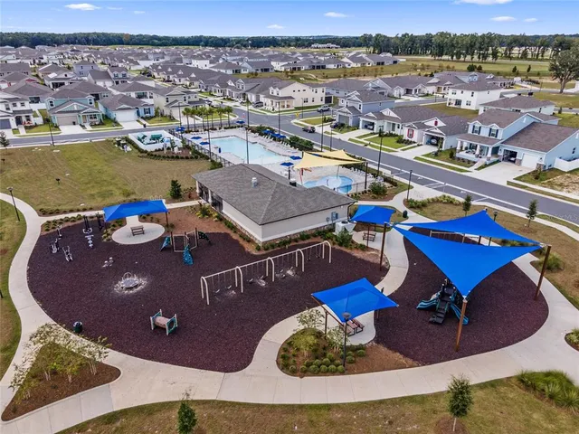 an aerial view of a house yard swimming pool and ocean view