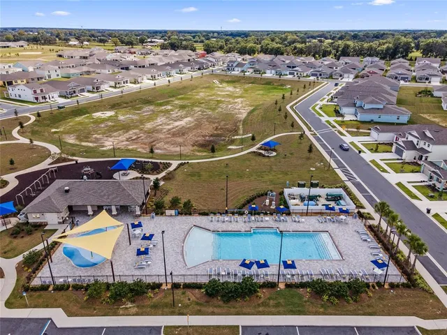 an aerial view of residential houses with outdoor space