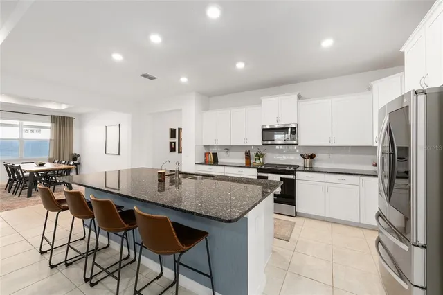 a kitchen with granite countertop a counter space a sink appliances and cabinets