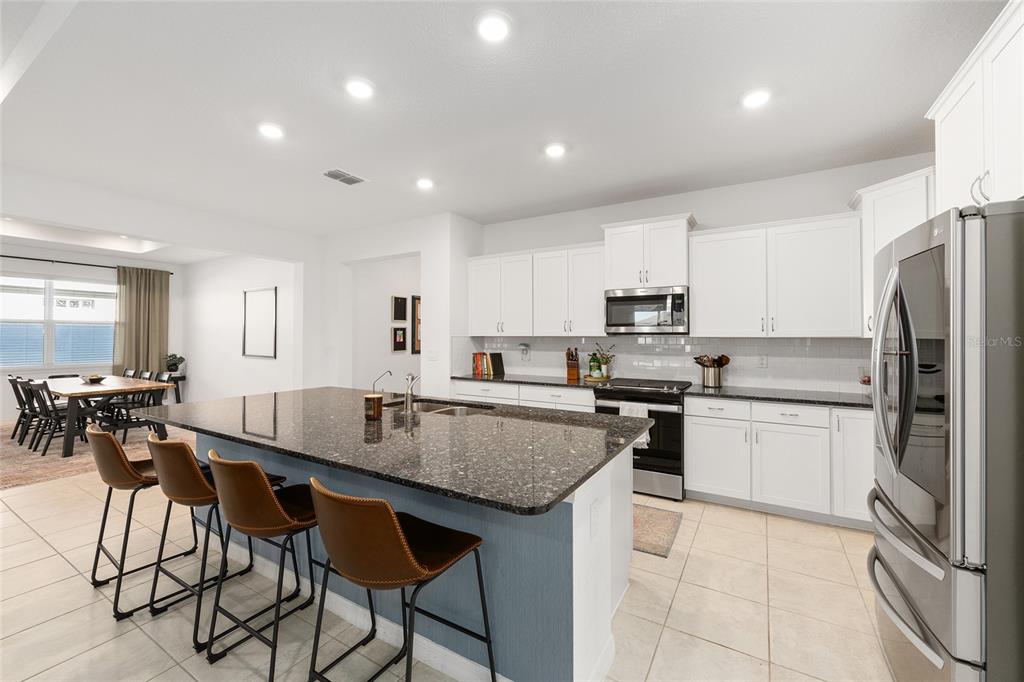 7431 Southwest 65th Place Road Ocala, FL 34474 - Photo 7 of 49 a kitchen with granite countertop a counter space a sink appliances and cabinets