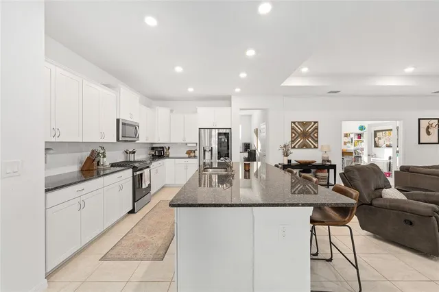 a large kitchen with stainless steel appliances lots of counter top space