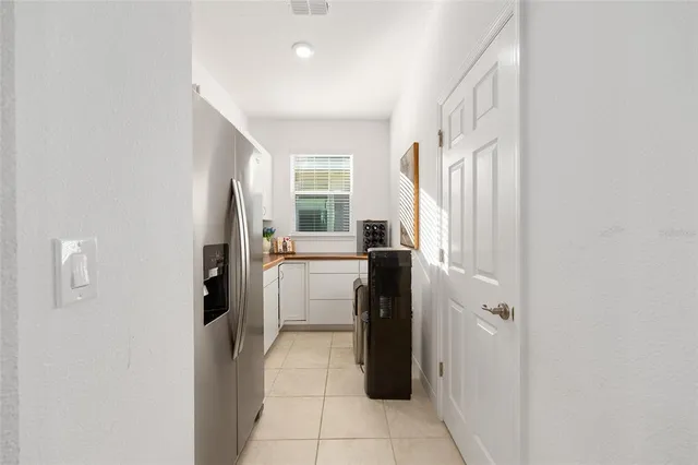 a kitchen with a refrigerator and washer