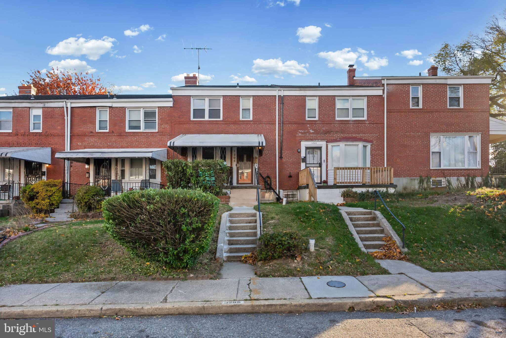 1205 Sheridan Avenue Baltimore, MD 21239 - Photo 1 of 22 Charming brick townhomes with lush greenery.