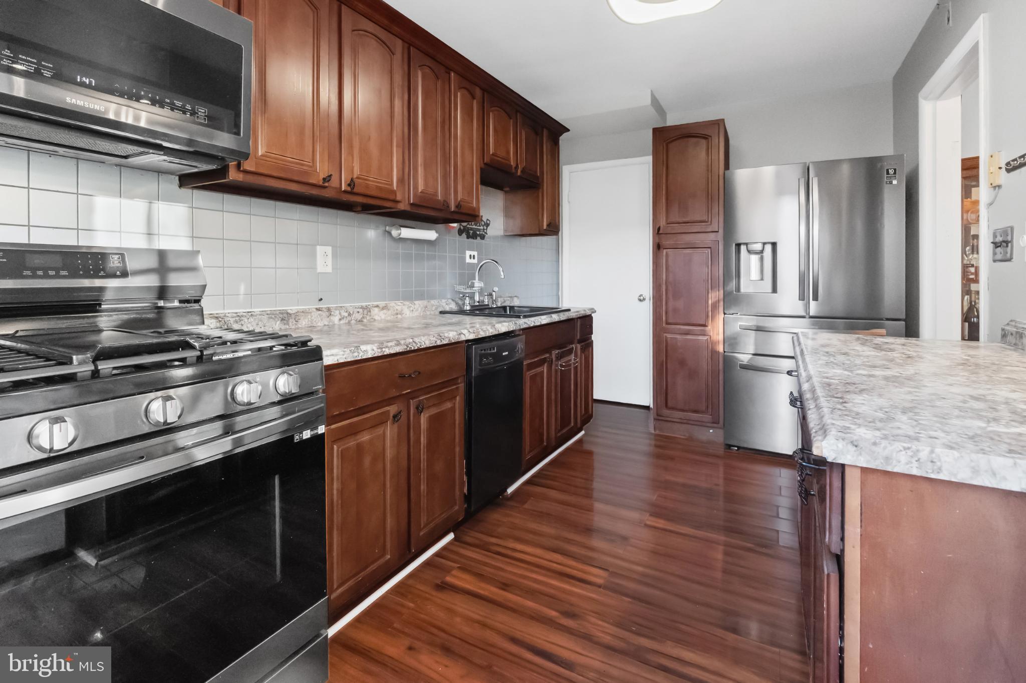 1205 Sheridan Avenue Baltimore, MD 21239 - Photo 9 of 22 Modern kitchen with rich wood cabinetry.