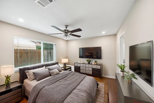 a bedroom with a bed and a flat screen tv