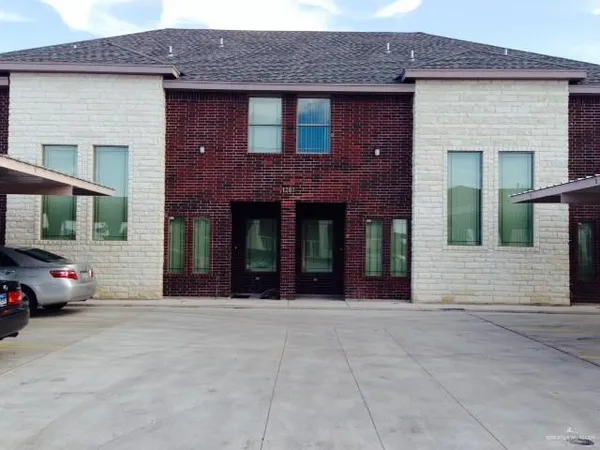 a view of a brick house with a large windows