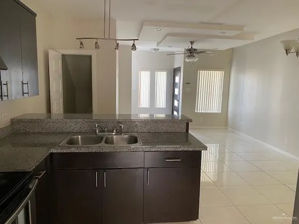 a kitchen with a sink stove and microwave