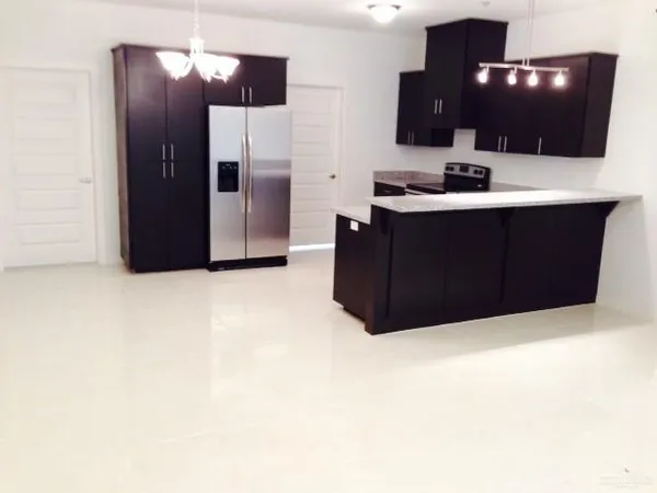 a kitchen with a refrigerator and a sink