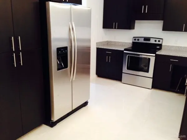 a kitchen with a refrigerator and a stove