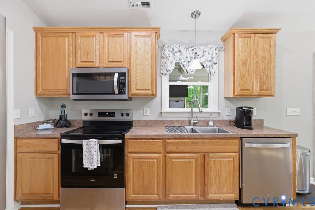 5307 St Pauls Church Road Goochland, VA 23063 - Photo 17 of 44 a kitchen with kitchen island granite countertop a sink stainless steel appliances and cabinets