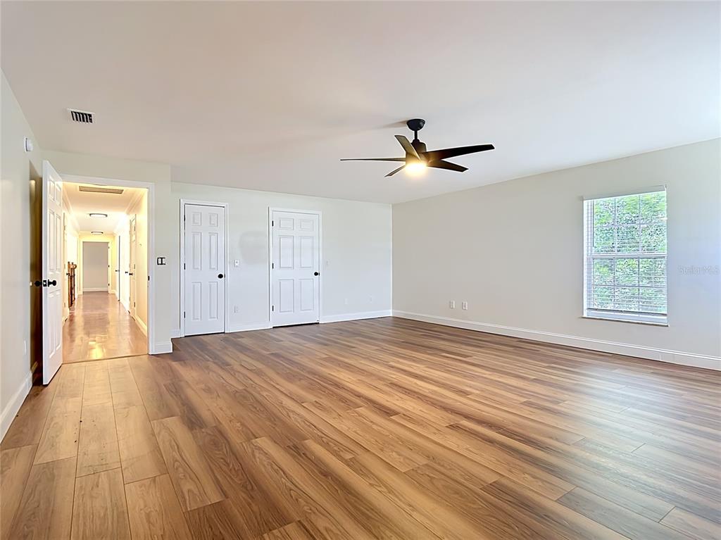 7925 Lake Mabel Loop Road Lake Wales, FL 33898 - Photo 44 of 97 a view of a livingroom with wooden floor and a ceiling fan