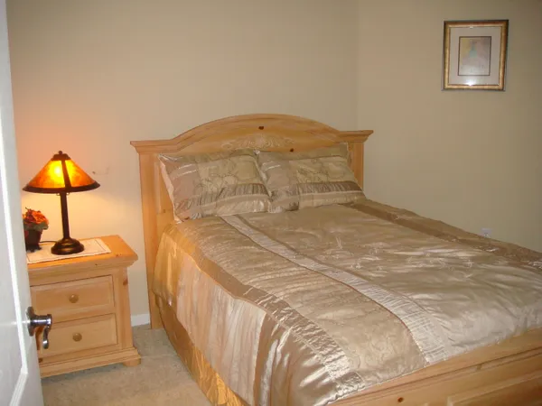a bedroom with a bed and a lamp