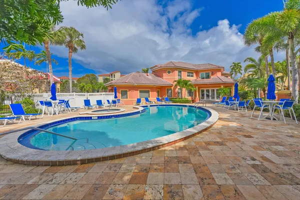 an outdoor space with swimming pool and furniture