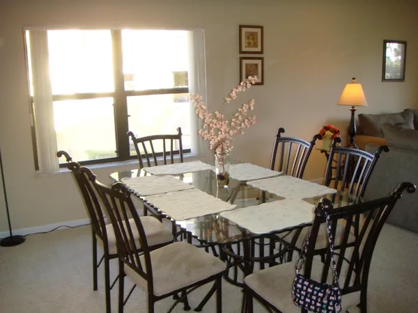 a view of a dining room with furniture and window
