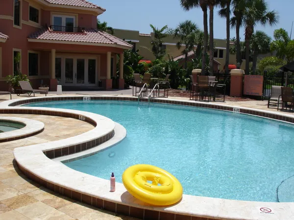 a view of a house with swimming pool and porch