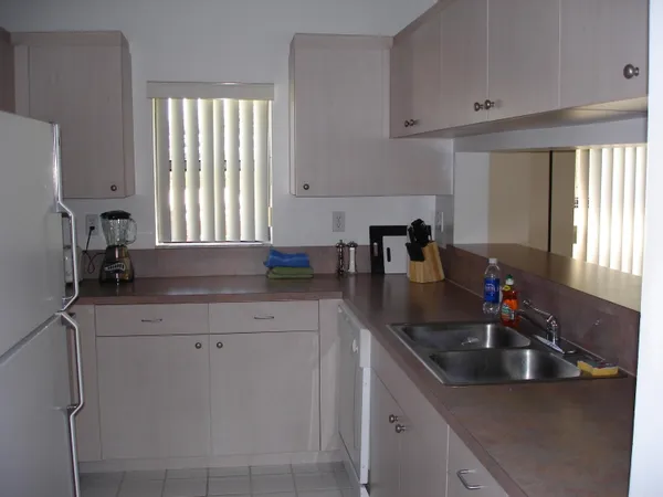 a kitchen with stainless steel appliances a sink a window and counter space