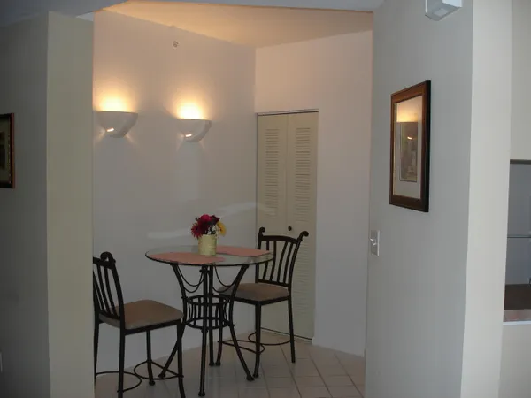 a view of a room that has a table and chairs in it