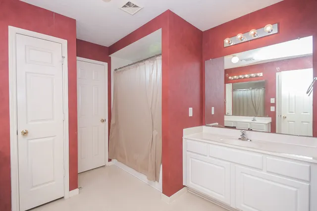 a bathroom with a sink vanity and mirror