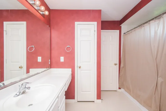 a bathroom with a sink a mirror and a shower