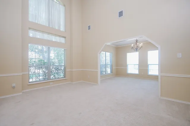 an empty room with windows and entrance