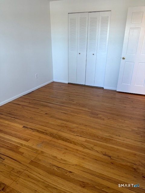 280 East Main Street, Unit E2 Clinton, CT 06413 - Photo 14 of 20 The second bedroom has hardwood floors and a double closet.