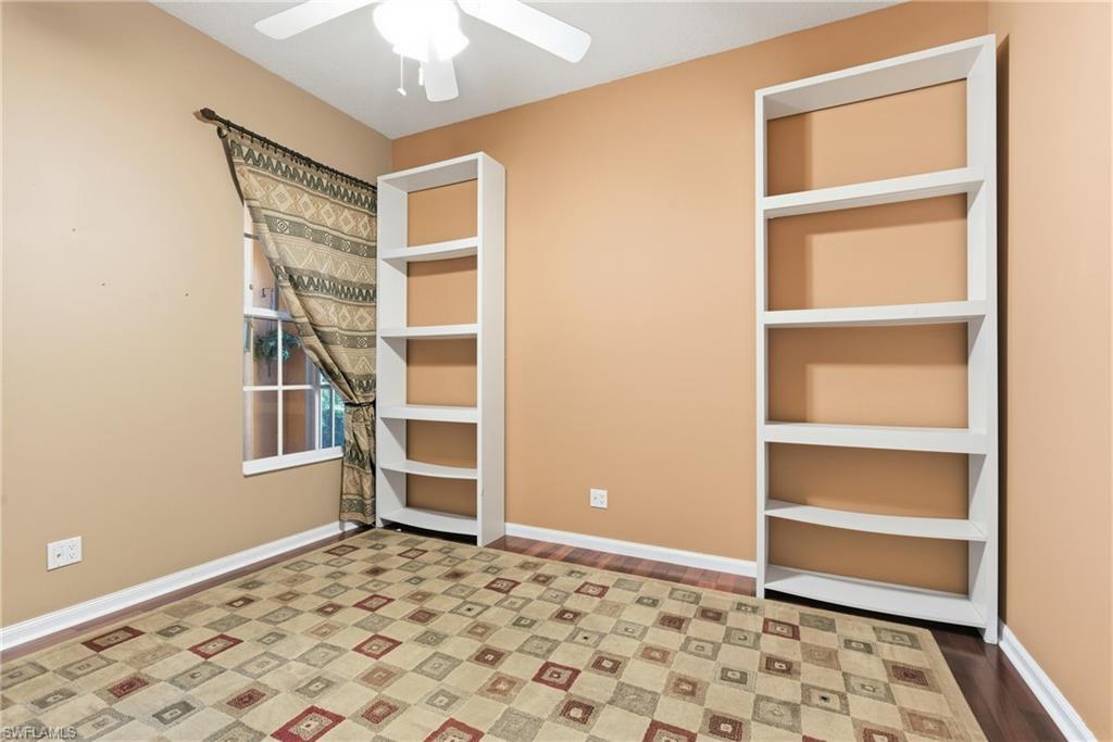 5902 Bermuda Lane Naples, FL 34119 - Photo 13 of 18 a big room with closet and wooden floor