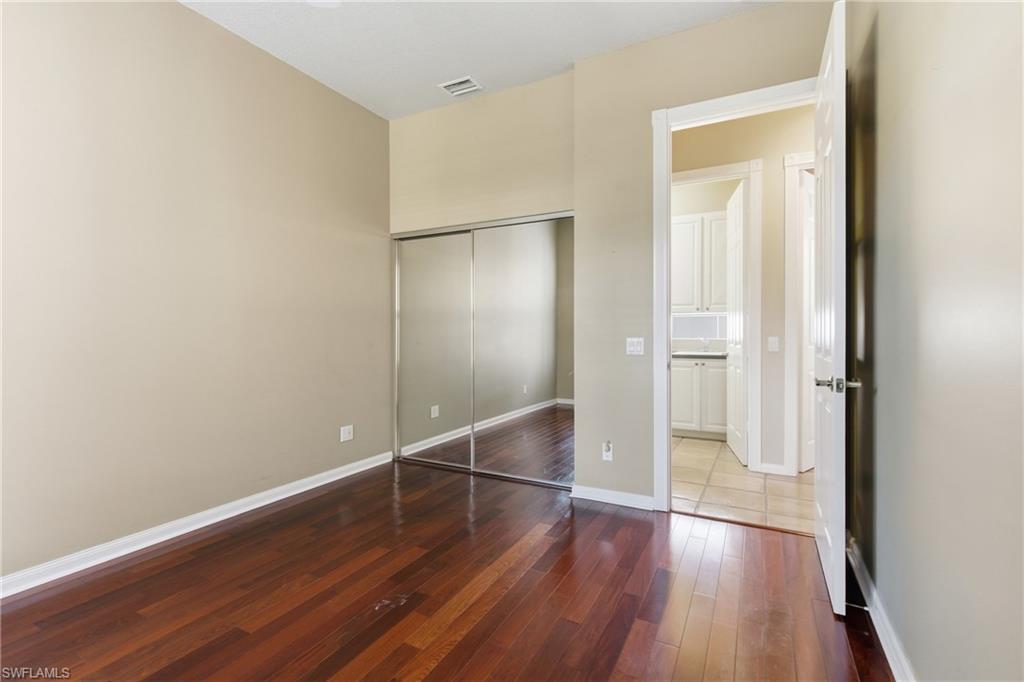 5902 Bermuda Lane Naples, FL 34119 - Photo 15 of 18 a view of an empty room with wooden floor