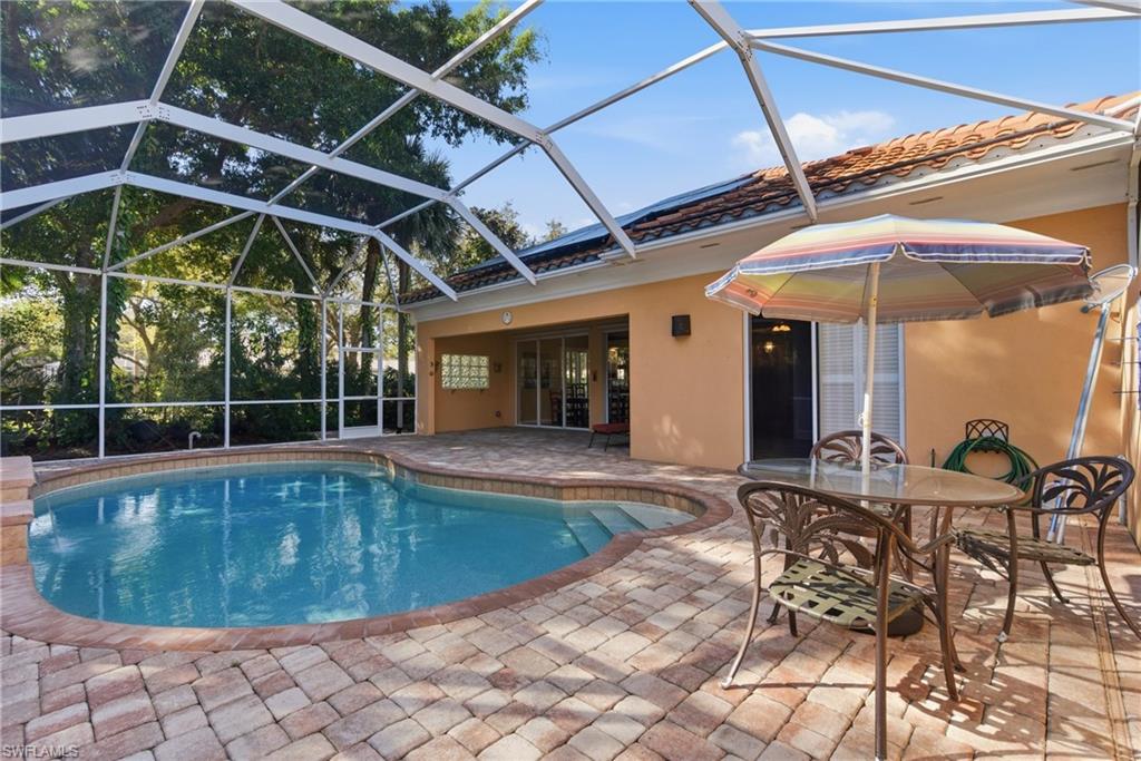 5902 Bermuda Lane Naples, FL 34119 - Photo 18 of 18 a view of a swimming pool with a patio