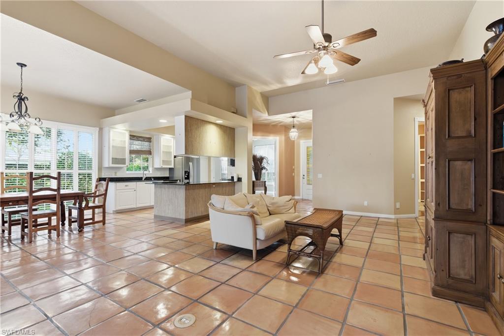 5902 Bermuda Lane Naples, FL 34119 - Photo 6 of 18 a living room with couches and kitchen view with wooden floor
