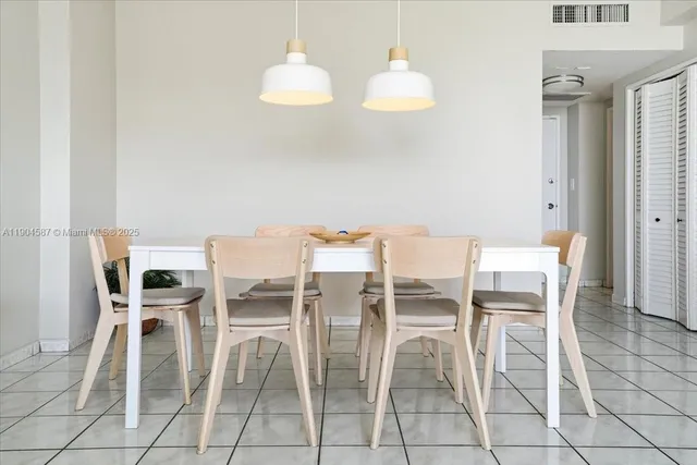 a dining room with furniture and a mirror