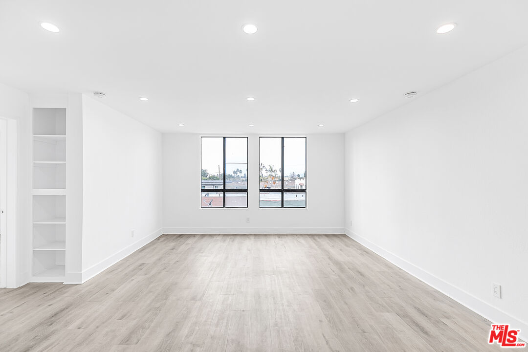 4115 Normal Avenue Los Angeles, CA 90029 - Photo 6 of 7 an empty room with wooden floor and windows
