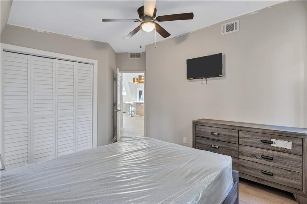 1920 Moores Mill Road Northwest Atlanta, GA 30318 - Photo 12 of 33 a bedroom with a bed and a flat screen tv