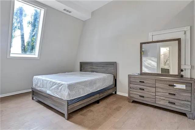 a bedroom with a bed and a dresser