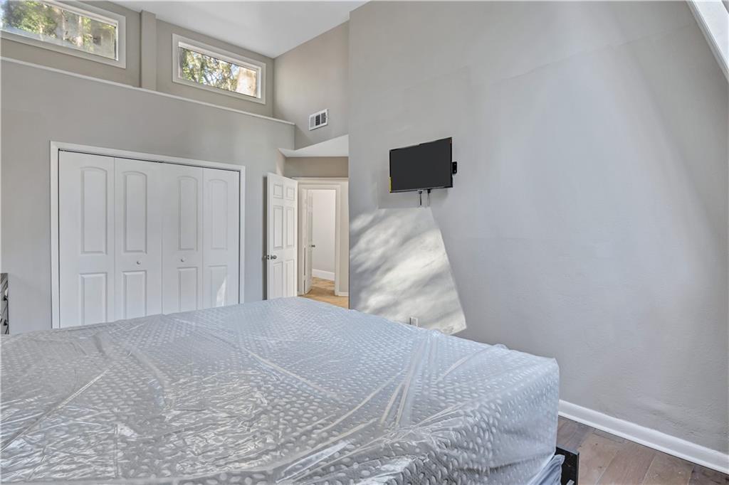 1920 Moores Mill Road Northwest Atlanta, GA 30318 - Photo 14 of 33 a bedroom with a bed and a night stand