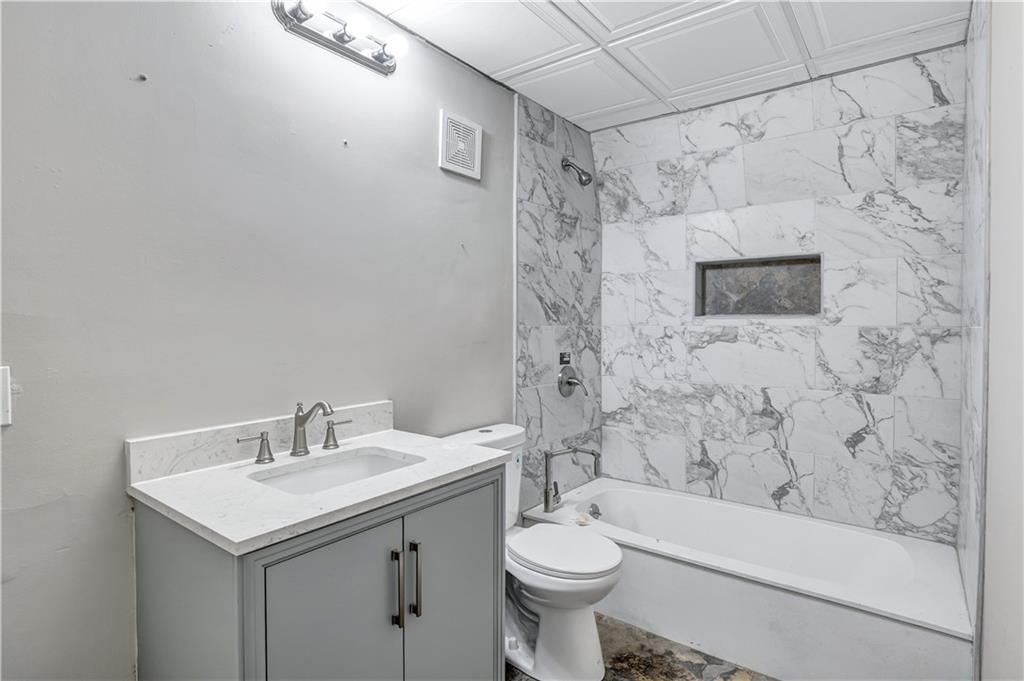 1920 Moores Mill Road Northwest Atlanta, GA 30318 - Photo 17 of 33 a bathroom with a sink toilet and shower