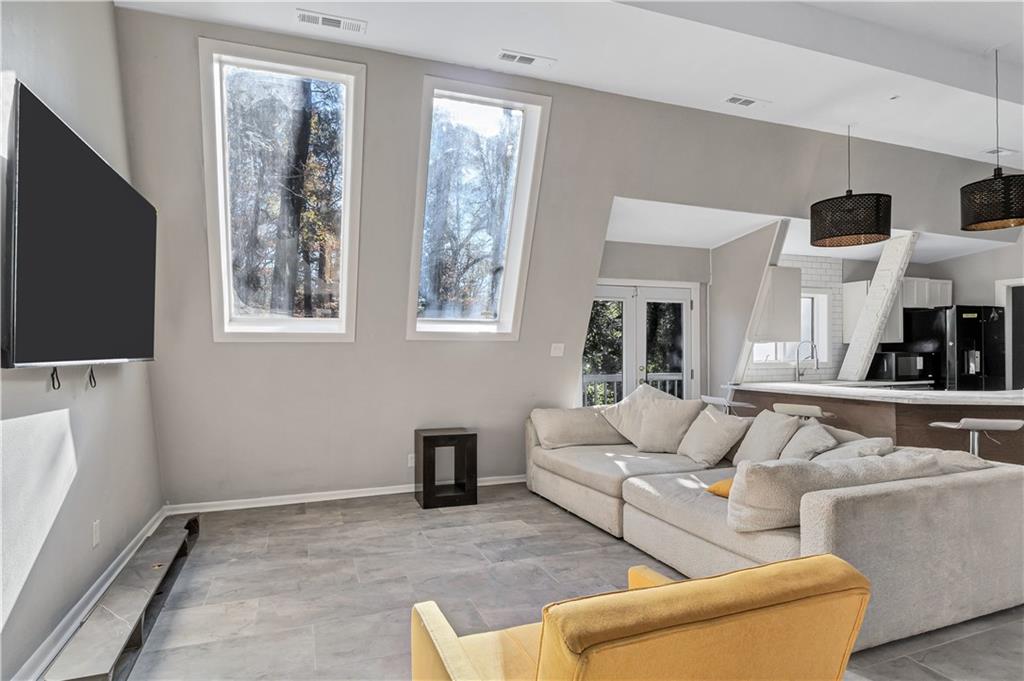 1920 Moores Mill Road Northwest Atlanta, GA 30318 - Photo 18 of 33 a living room with furniture and a flat screen tv