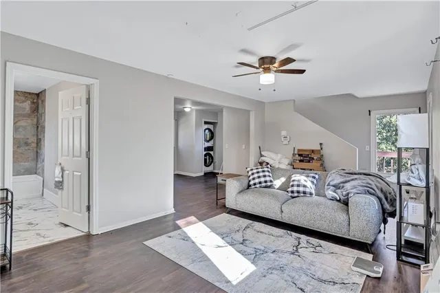 a living room with furniture and a ceiling fan