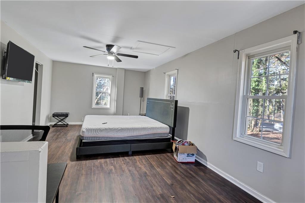 1920 Moores Mill Road Northwest Atlanta, GA 30318 - Photo 26 of 33 a bedroom with a bed and a flat tv screen on the dresser