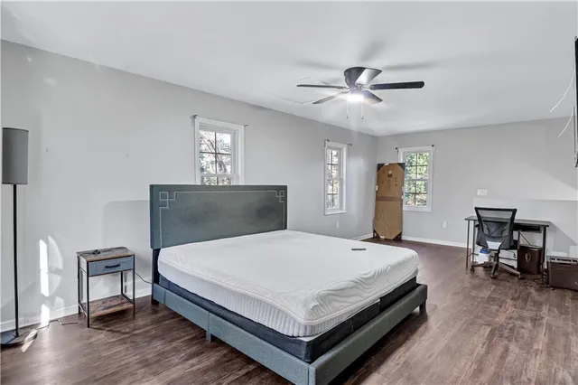 a bedroom with a bed a table and chair