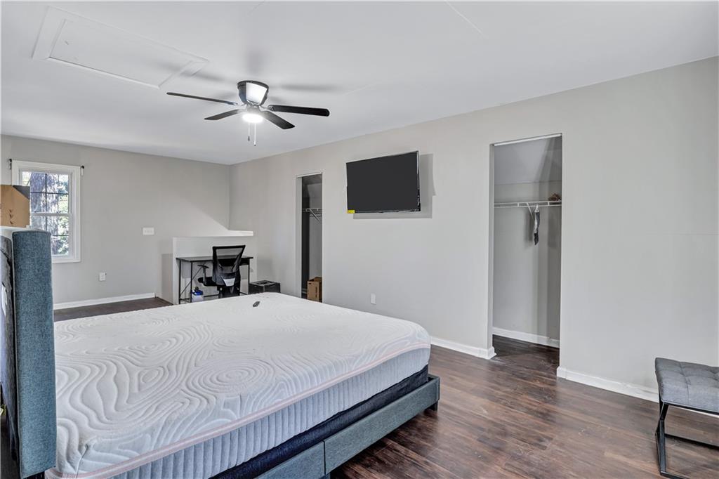 1920 Moores Mill Road Northwest Atlanta, GA 30318 - Photo 29 of 33 a bedroom with a bed and a flat screen tv